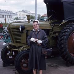 Woman standing with a tractor