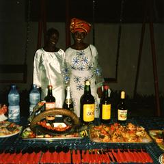 Women in front of table of food