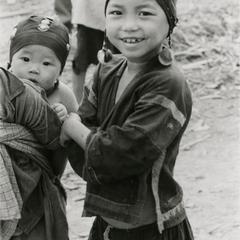 An Akha girl stands next to her brother with infant in the village of Phate in Houa Khong Province