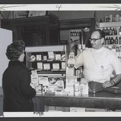 Woman looks at display of drugstore hearing aids