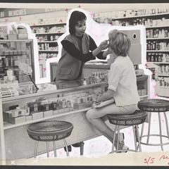 Cosmetics clerk puts makeup on a woman at a cosmetics counter