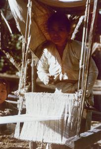 A White Lahu (Lahu Hpu) woman weaves in the village of Chalopha in Houa Khong Province