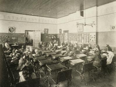 Normal school student teacher instructing children in the primary department