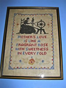 "Mother's love" cross-stitched sampler in blue and red