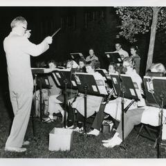 Stout Band performing outside, sitting at music stands