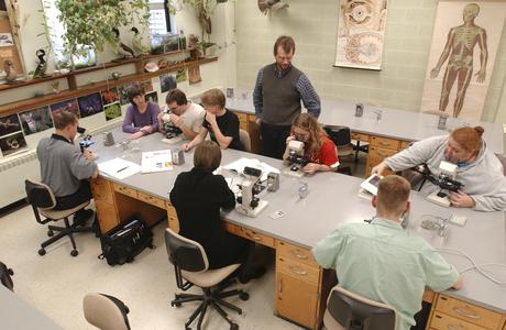 Students use microscopes during biology lab