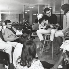 Student plays the guitar for friends