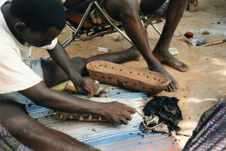Final Pegging the Goat Skin on the Wooden Body of the Ngoni