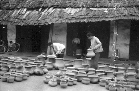 Lao women selling pottery from nearby village