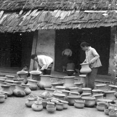Lao women selling pottery from nearby village