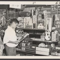 A young boy looks at toys in a toy display