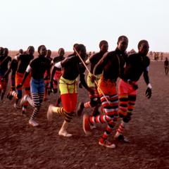 Nuer Men Dancing in Pairs with Colorful Leggings