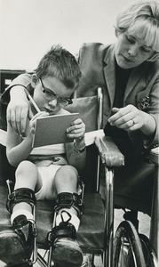 Social worker with child in wheelchair