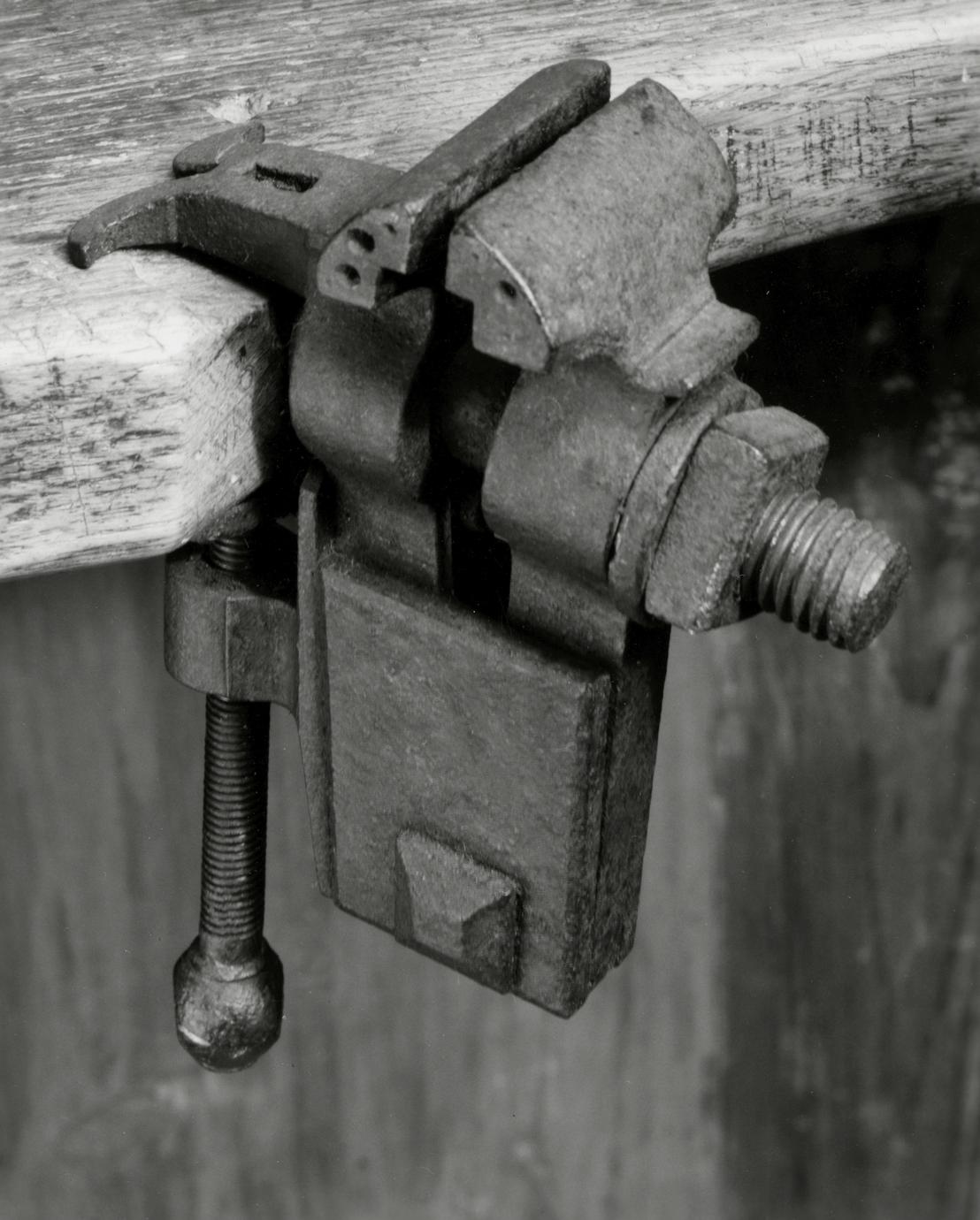 Black and white photograph of a bench vise.