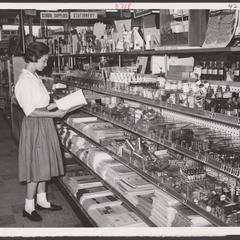 A young shopper selects school supplies from a drugstore display