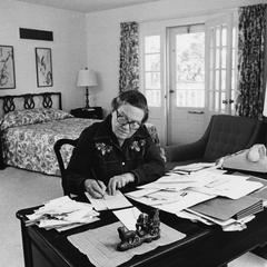 Phyllis Smart Young sits writing at a desk