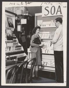 A pharmacist helps a customer select a soap product