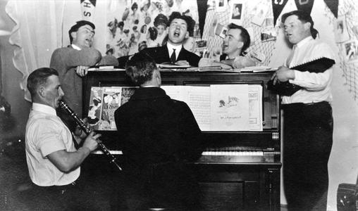 Young men around a piano