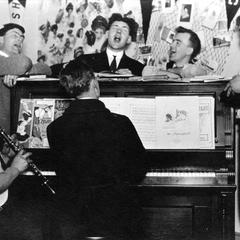 Young men around a piano