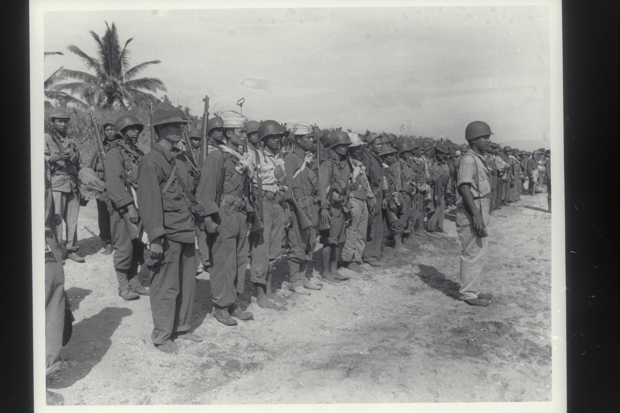 Guerrillas stand in formation on beach, Masbate, 1945