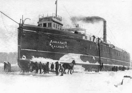 Men and horses work to free the Ann Arbor No.1 from the ice