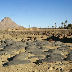Rock Bed of Desert with "Ideles" Village in Background