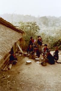 Yao (Iu Mien) women gathered in front of a dwelling in Houa Khong Province