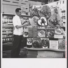 A pharmacist looks over a display of Valentine's candy