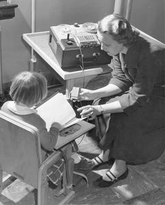 Woman Recording Girl Reading