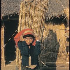 Kammu (Khmu') woman carrying thatch