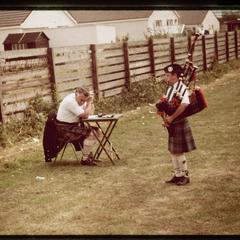 Young piper and judge, 1984 Blairgowrie Highland Games