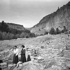 Women walking among ruins at Frijoles Canyon