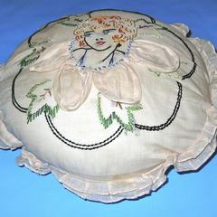 Round cream-colored organdy pillow