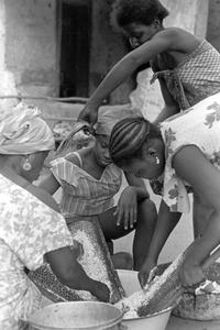 Women Grating Coconut for Making Oil