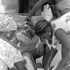 Women Grating Coconut for Making Oil