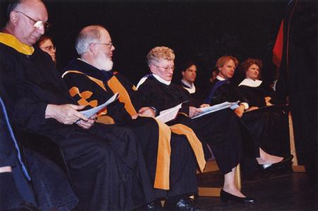 Professors on stage at commencement ceremony