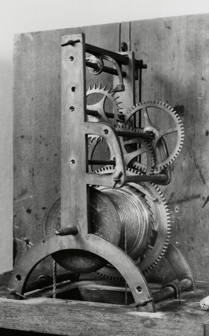 Black and white photograph of a timepiece gear system.