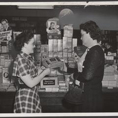 Two women view items in a drugstore display