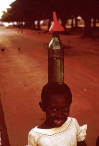 Young Girl Carrying Bottle on Her Head