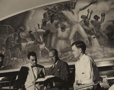 Men in front of mural