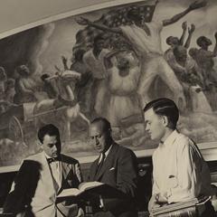 Men in front of mural