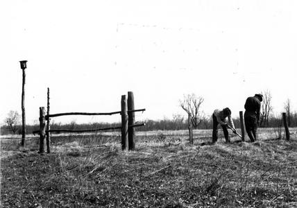 Aldo Leopold and Carl working on fence along Levee Road