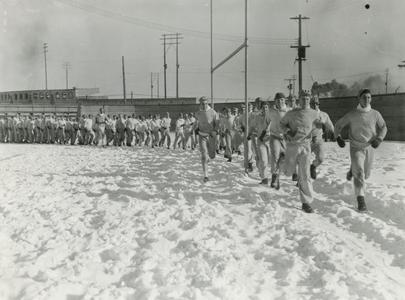 ROTC trainees drill in snow on football field