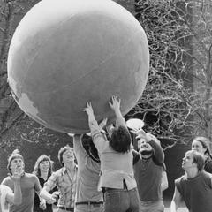 Students playing with Earth Ball on university grounds