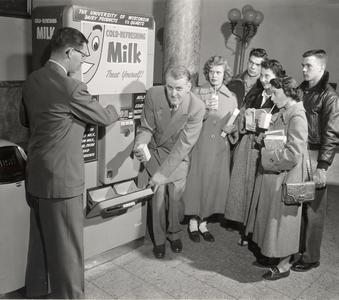 Rudolph K. Froker with a milk vending machine