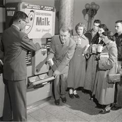 Rudolph K. Froker with a milk vending machine