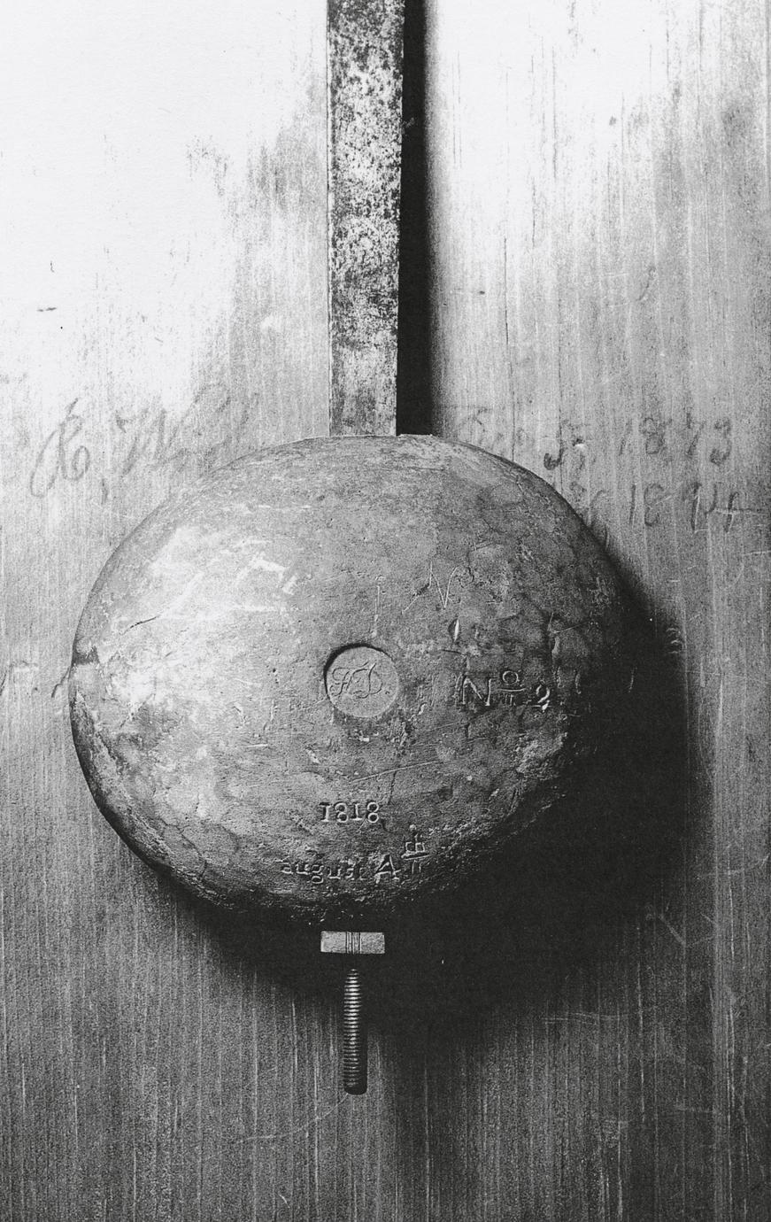 Black and white photograph of a silent clock pendulum.