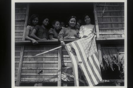 Filipino family shows U.S. flag, 1944
