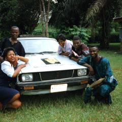 Group of interviewees posing by car