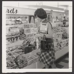 A woman selects candy at a candy counter